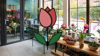 A flower shop showcasing a sizable window and a prominent flower arrangement, captured in a photograph.