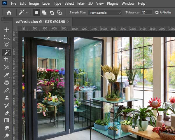 A flower-filled window framed by a rustic window frame, showcasing the beauty of a flower shop in Photoshop.