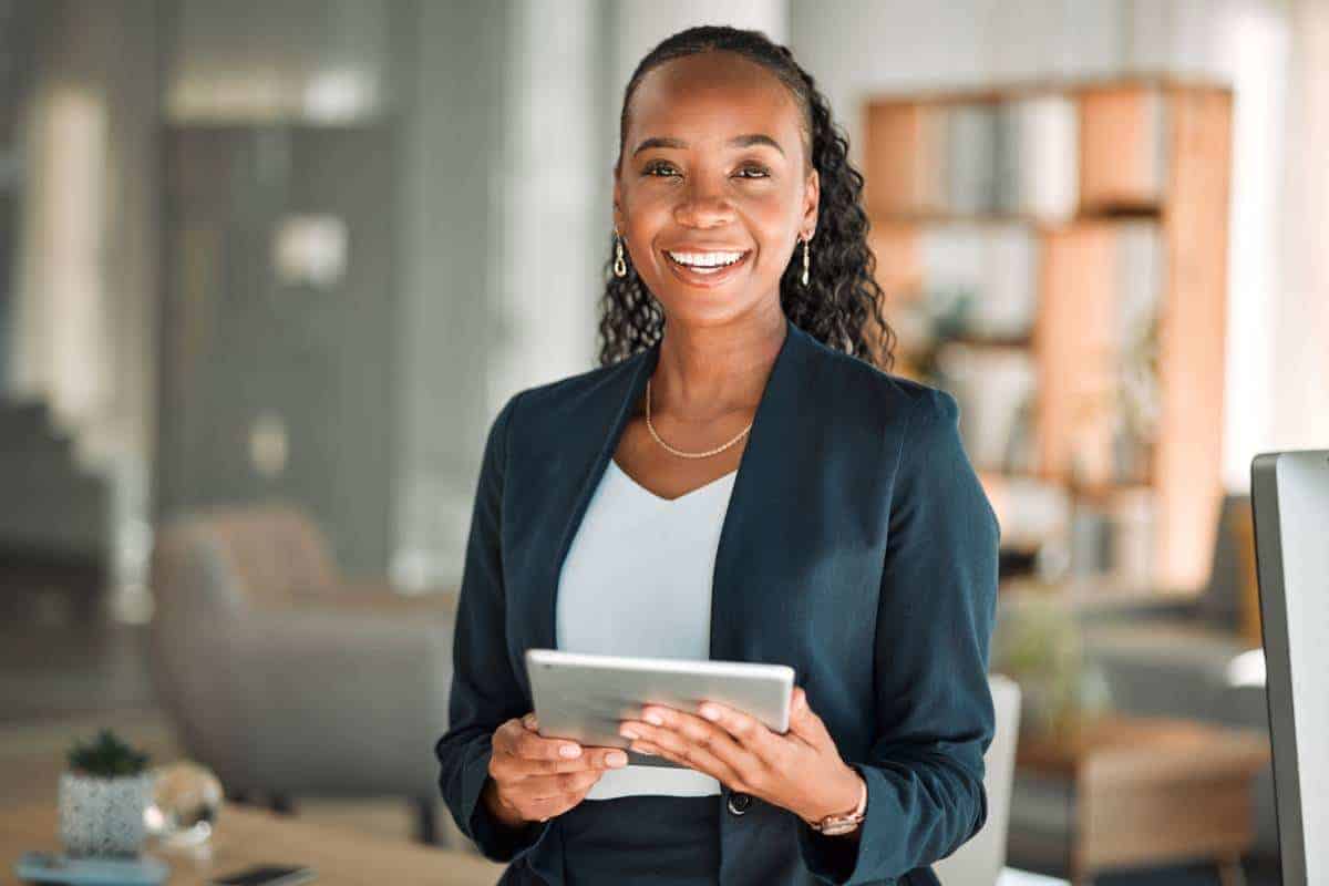 Lawyer Smiling with an Electronic Device in Her Hands