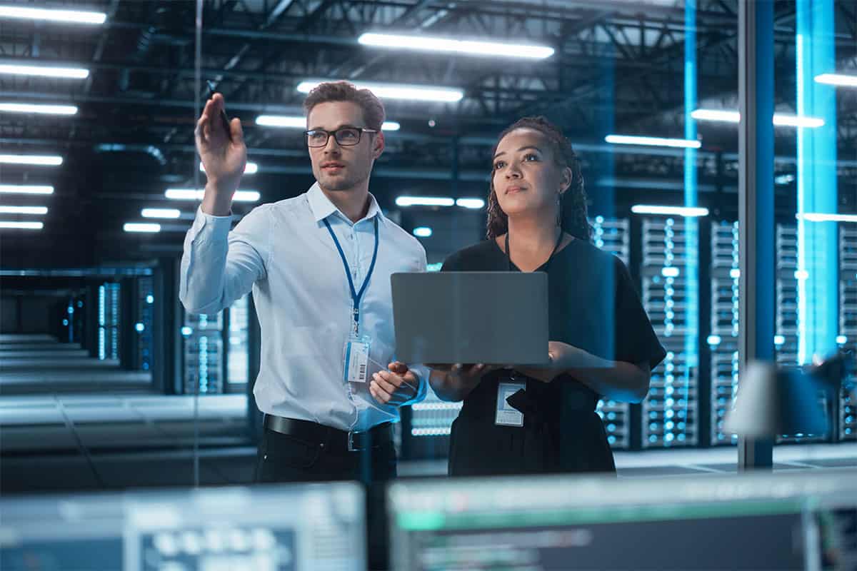 A business owner is consulting with an IT professional to overcome technology challenges.