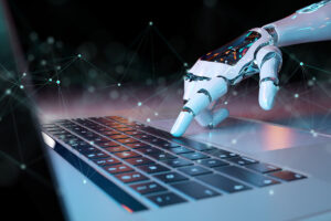 A robotic hand reaching towards a laptop keyboard, with a dark, abstract background featuring interconnected lines and dots representing technology and connectivity.